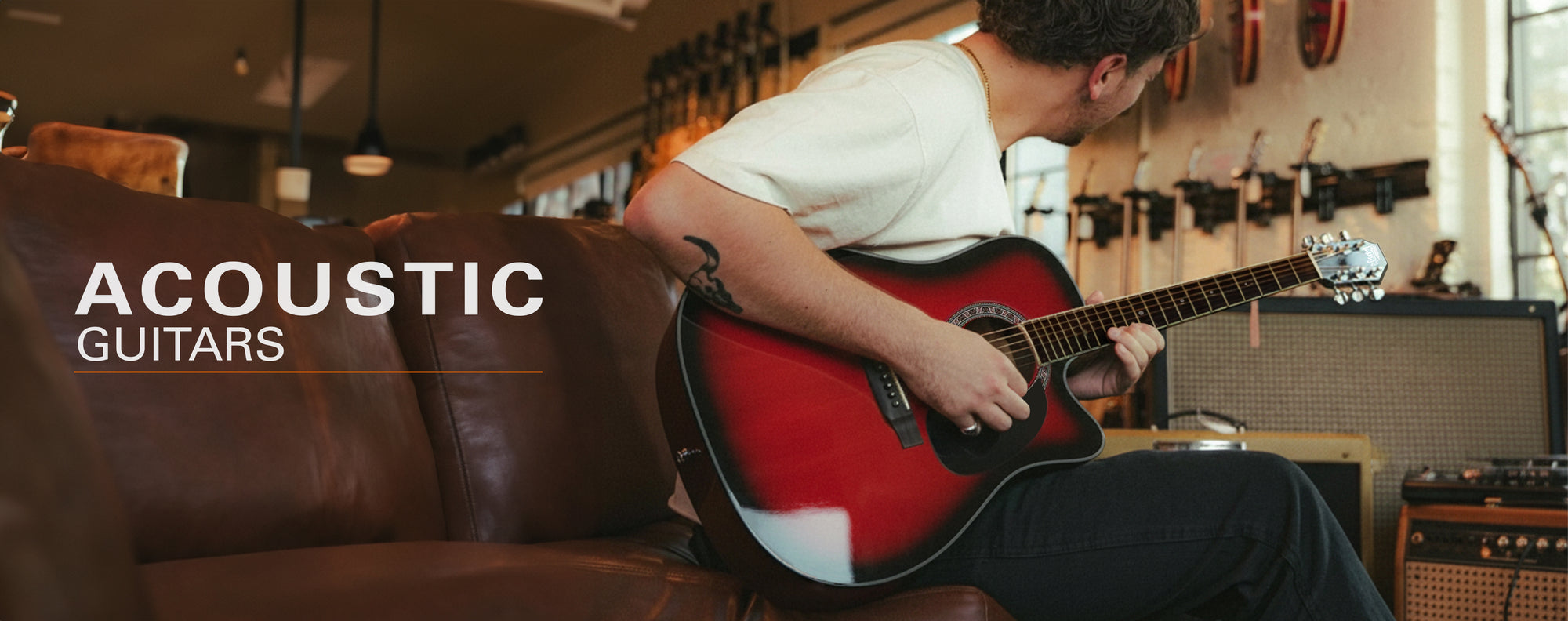 Person playing an acoustic guitar in a music store with 'Acoustic Guitars' text overlay.