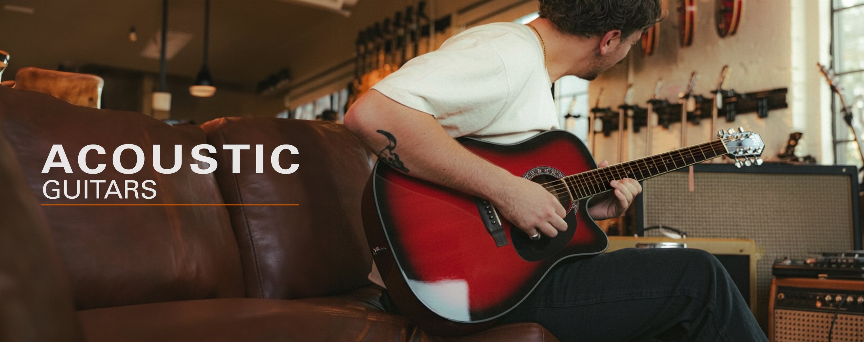 Person playing an acoustic guitar in a music store with 'Acoustic Guitars' text overlay.