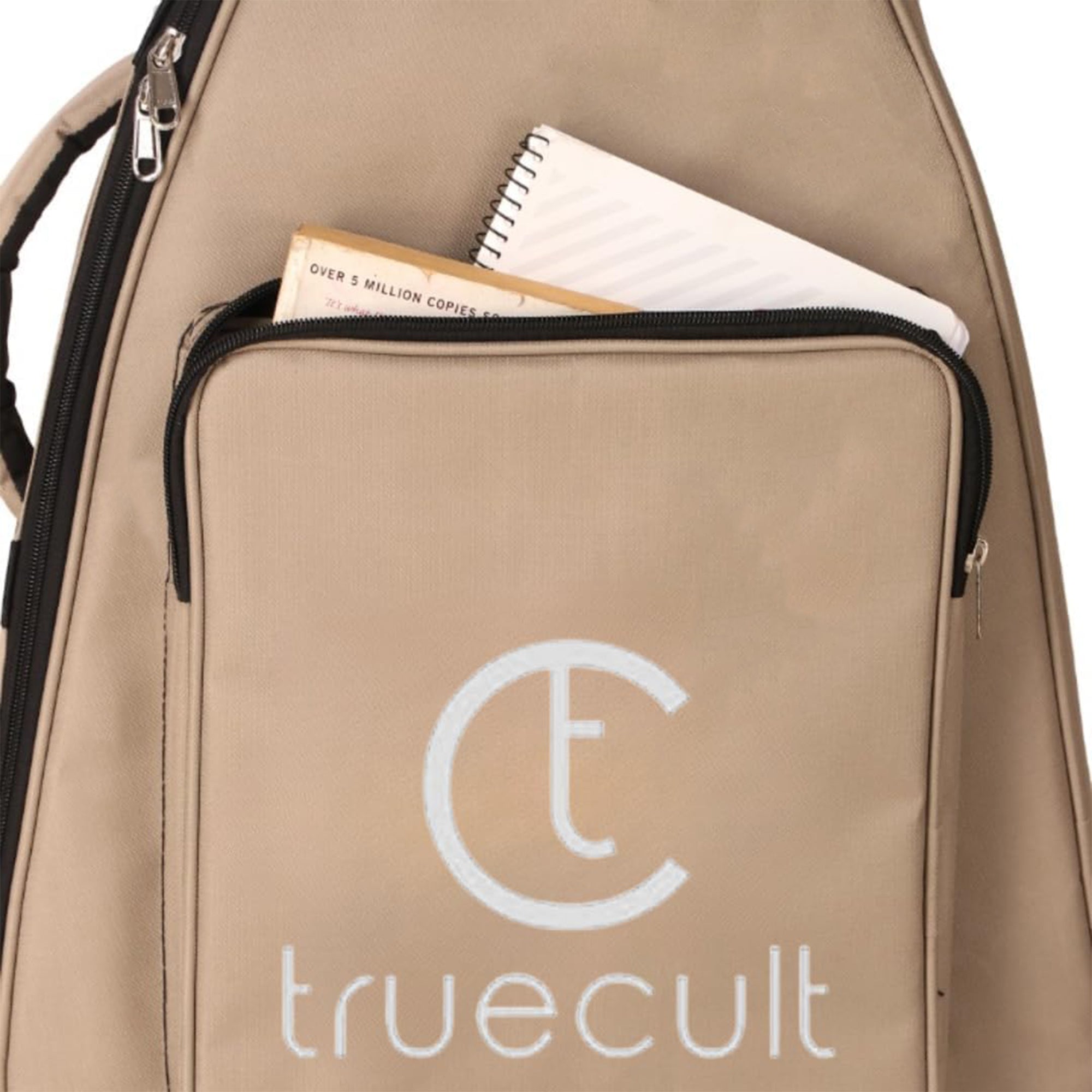 Beige bag with 'truecult' logo and items inside on a white background Water-resistant acoustic guitar gig bag for yamaha kadence fender 