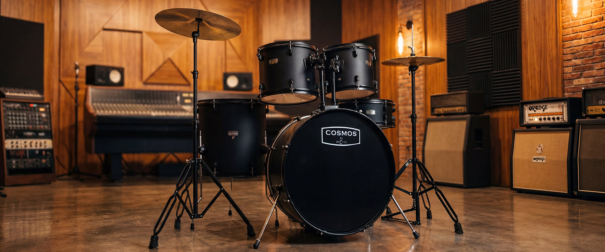 Desktop wide angle studio shot of a glossy black 5-piece acoustic drum set showcasing the hardware setup, white drumheads, and reflective chrome hoops.