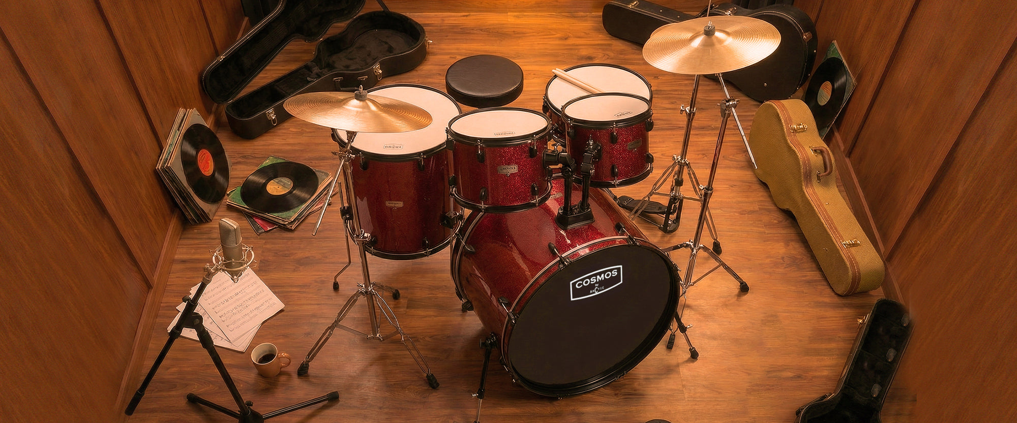 High-angle desktop display of a glossy red acoustic drum set, showing the hardware layout and reflective chrome rims.