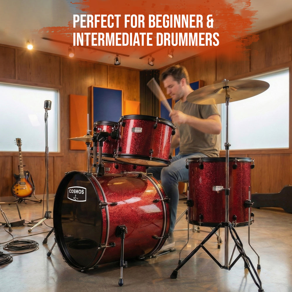 Side view of a red acoustic drum kit, highlighting the professional-grade hardware, cymbal stands, and shell depths.