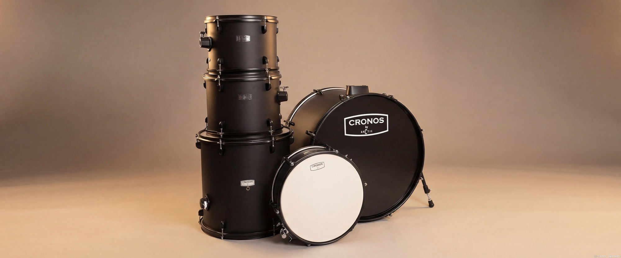 Close-up view of the black drum kit shells, highlighting the reflective finish, chrome hoops, and tension casings optimized for desktop users.