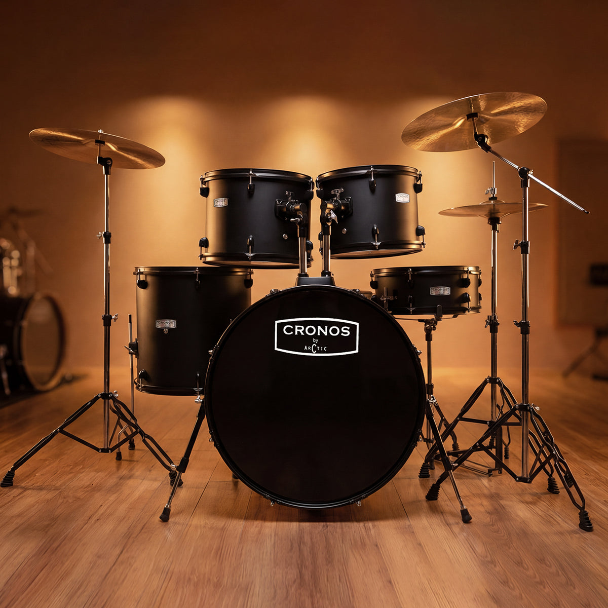 Three-quarter angled view of a black acoustic drum kit, highlighting the configuration of the rack toms, floor tom, and hardware.
