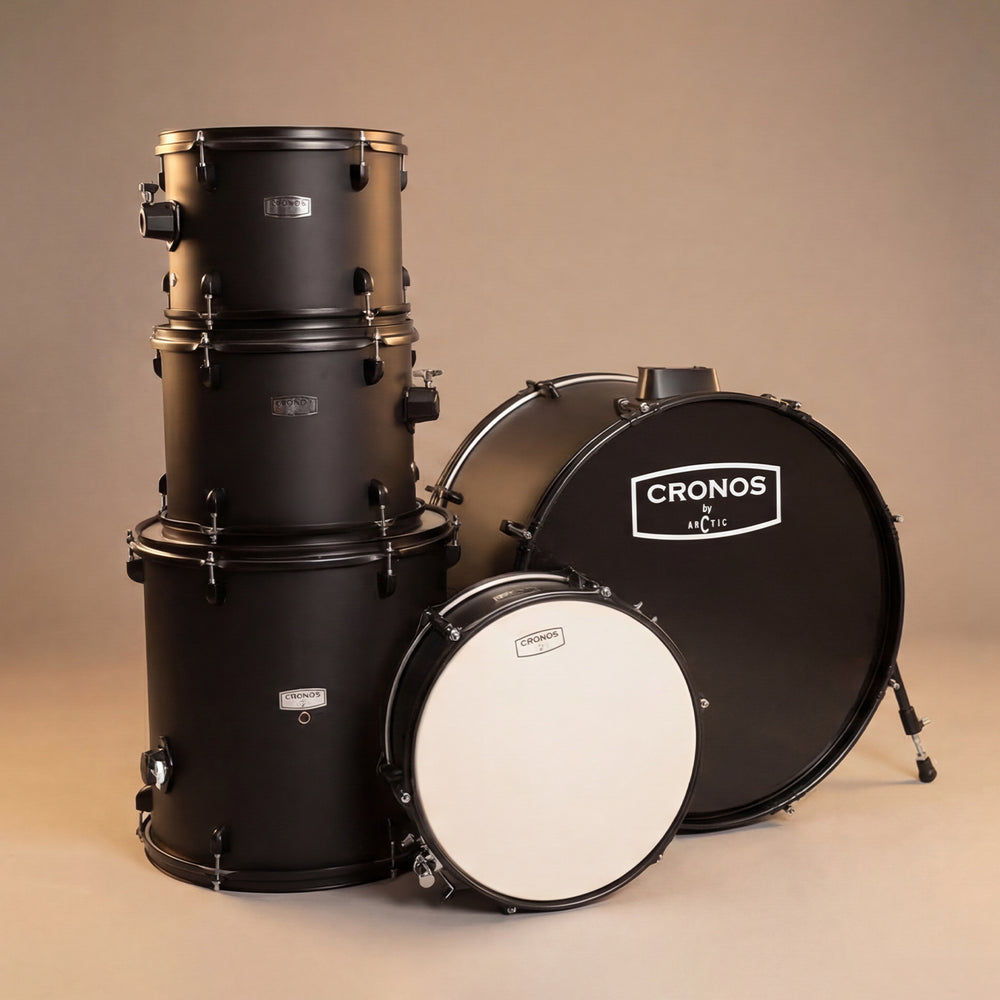 Close-up view of the black drum kit shells, highlighting the reflective finish, chrome hoops, and tension casings.
