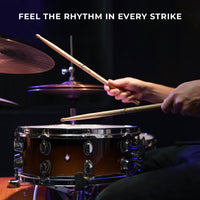 Person playing a drum set with 'Feel the Rhythm in Every Strike' text above.