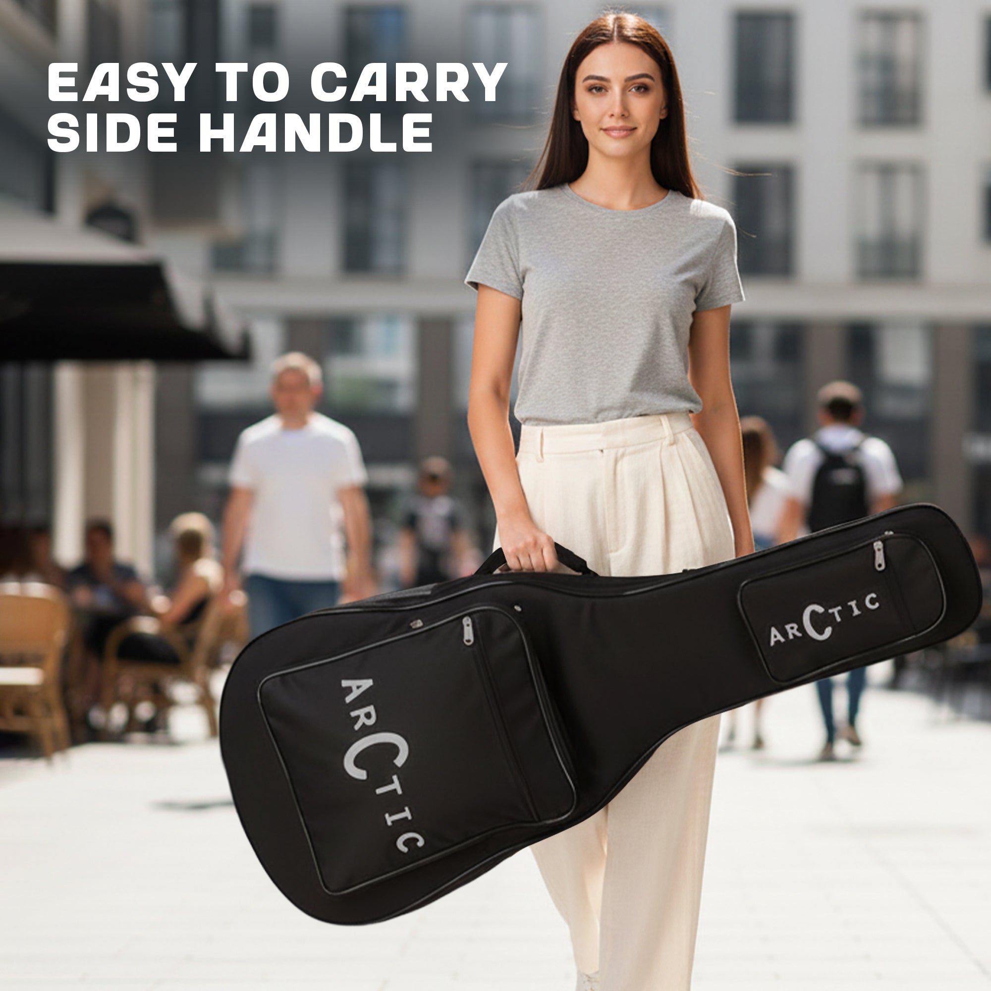 Woman holding a black guitar case with 'Arctic' branding in an urban setting.