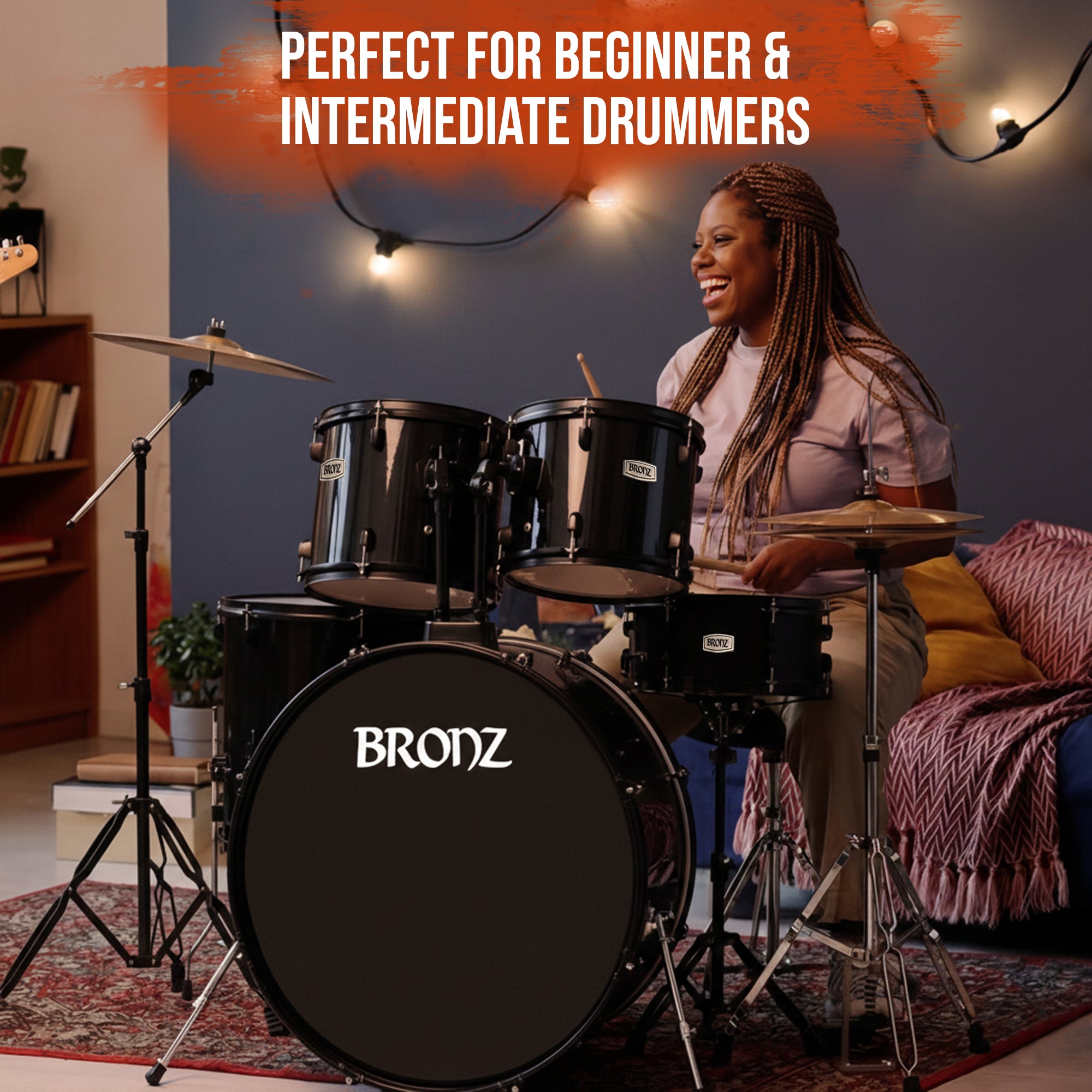 Woman playing a BRONZ drum set in a living room with text 'Perfect for Beginner & Intermediate Drummers'.