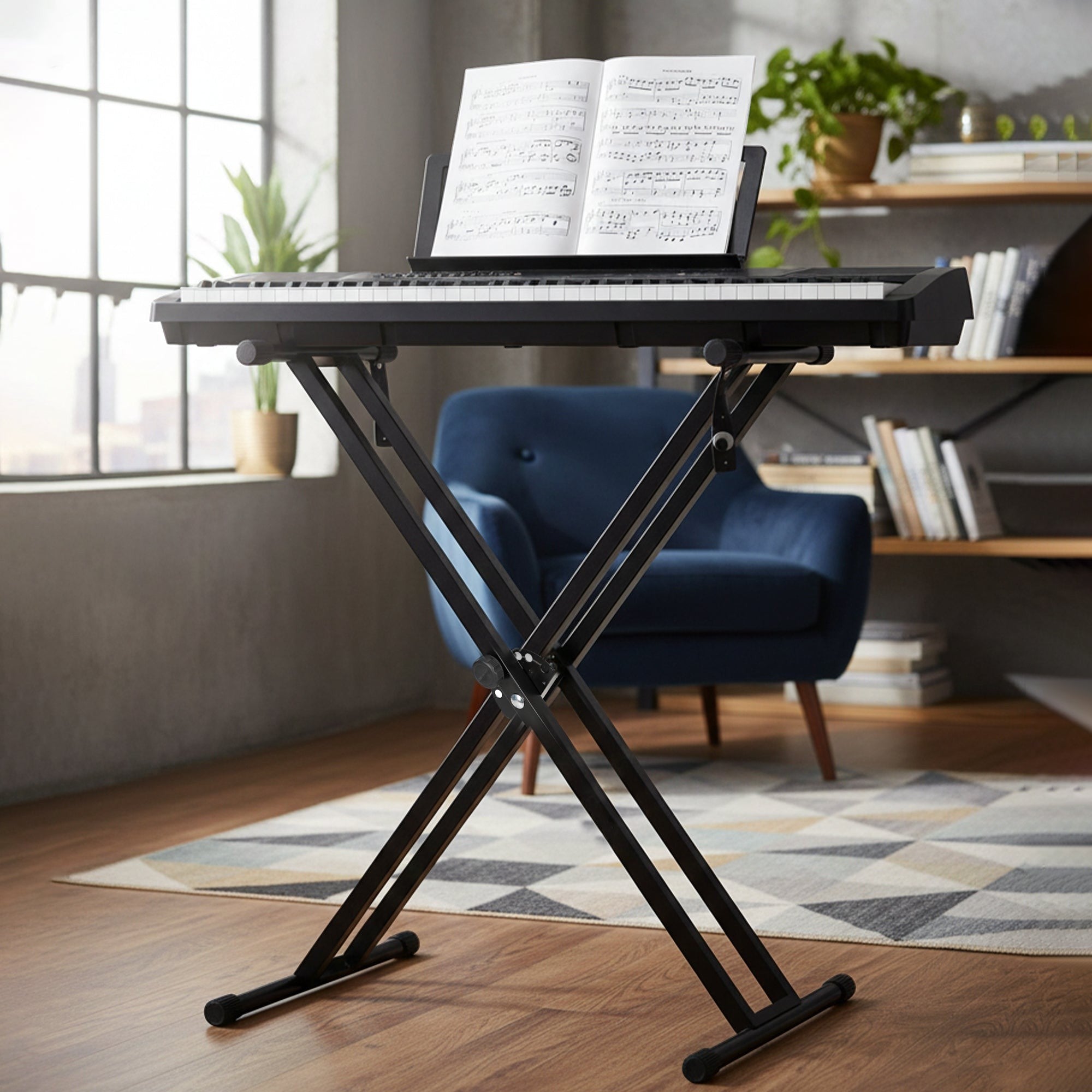Black adjustable stand with a laptop displaying music notes in a room with a blue chair and window.