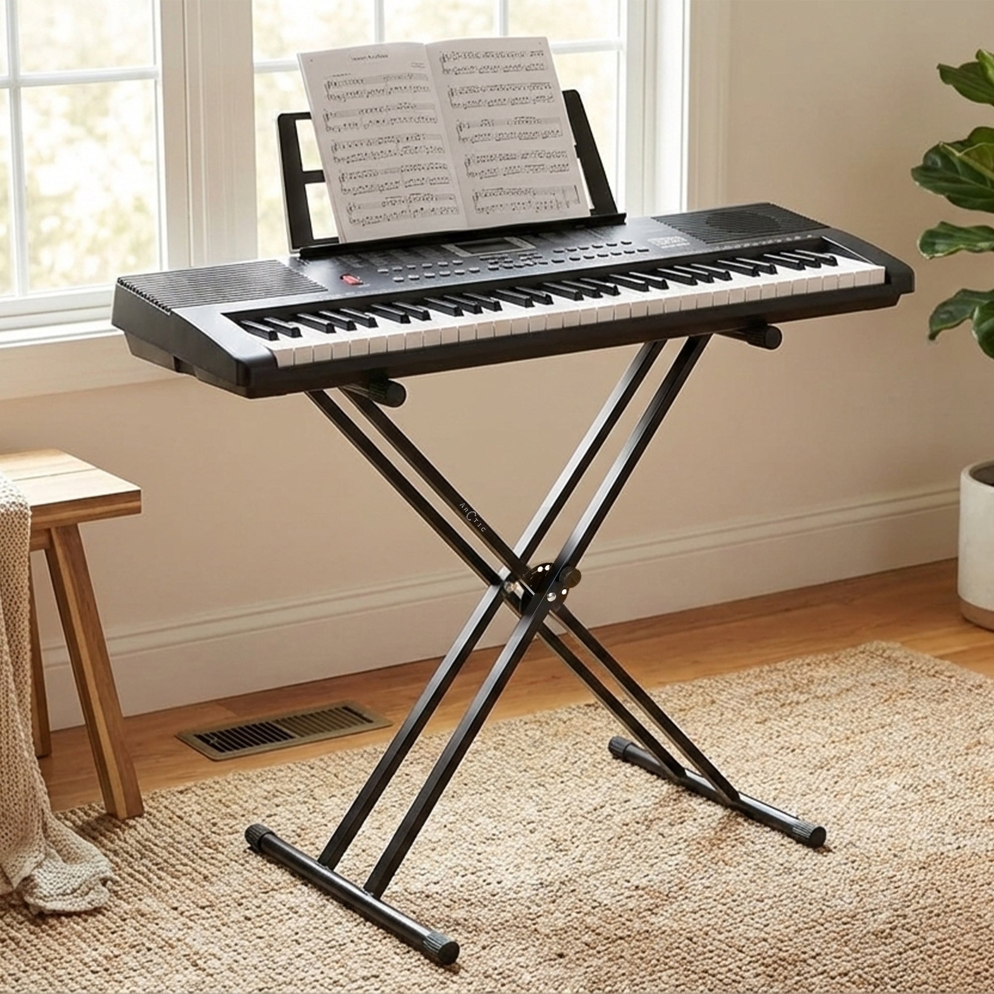 Keyboard with music stand in a room with a window and plant