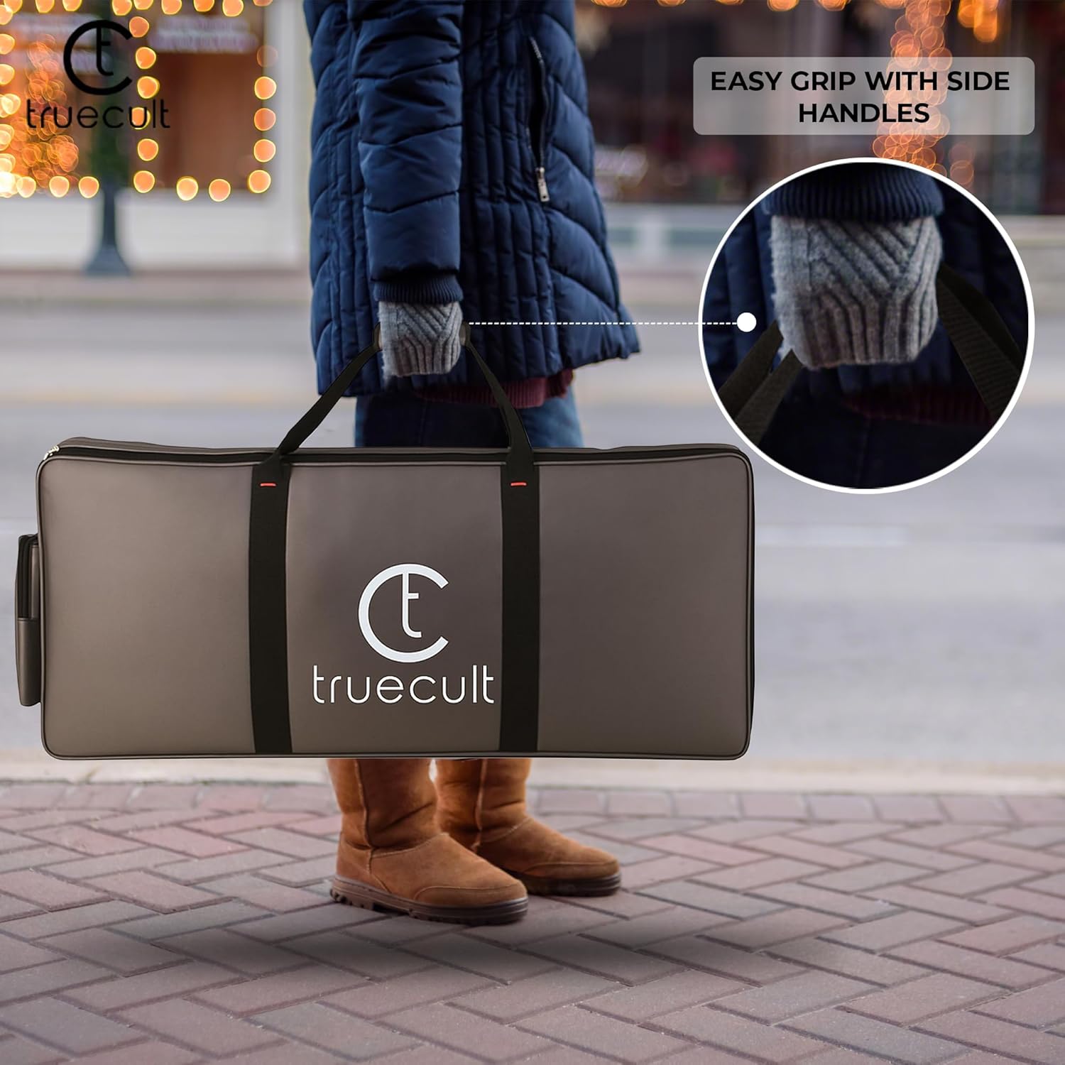 Person holding a truecult branded carrying case with an inset showing handles.