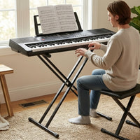 Person playing a digital piano in a home setting