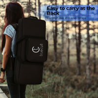Person carrying a black backpack with 'truecult' logo in a forest setting added 37-key keyboard bag for Yamaha Casio