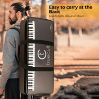 Person carrying a portable keyboard case with 'truecult' branding on a natural background.
