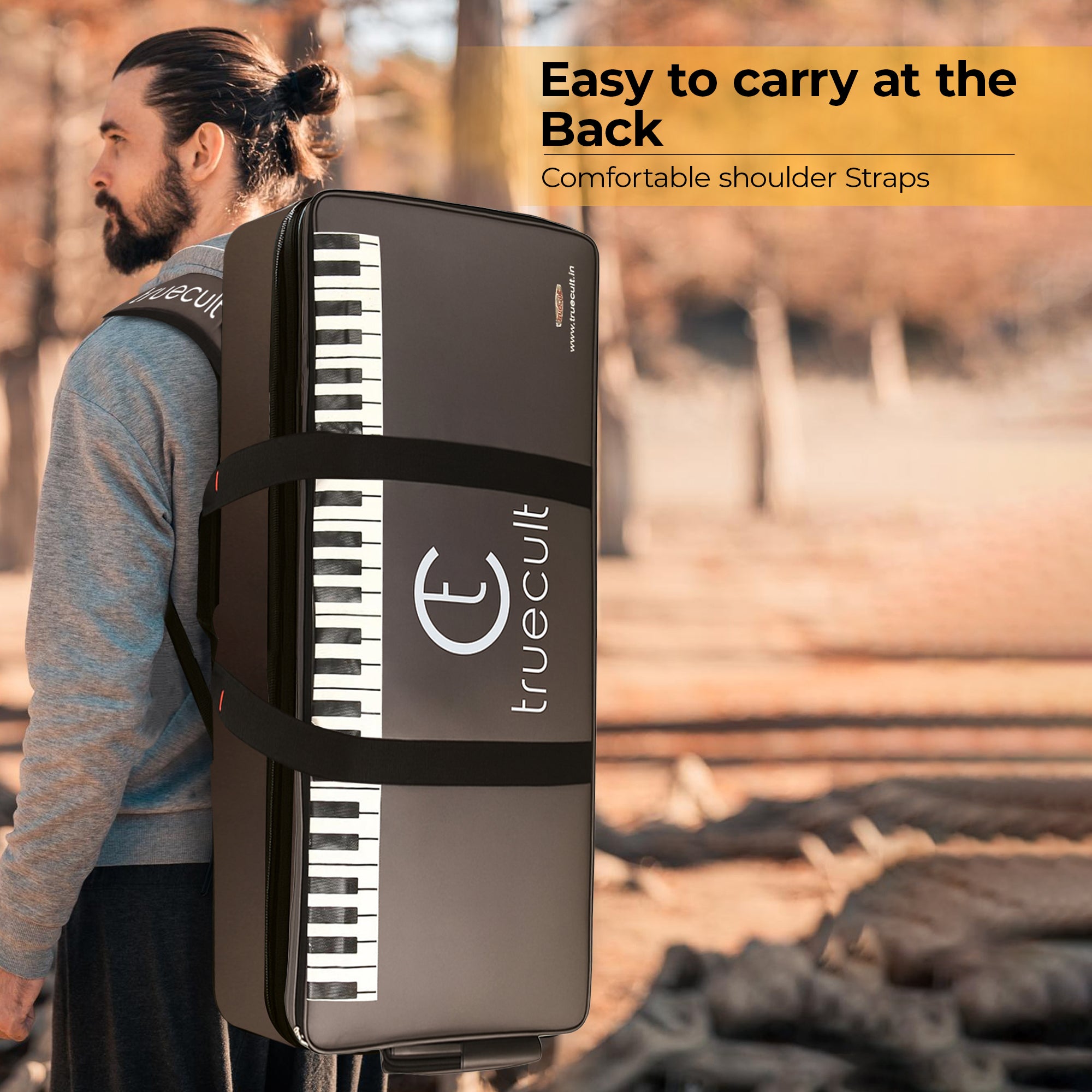 Person carrying a portable keyboard case with 'truecult' branding on a natural background.
