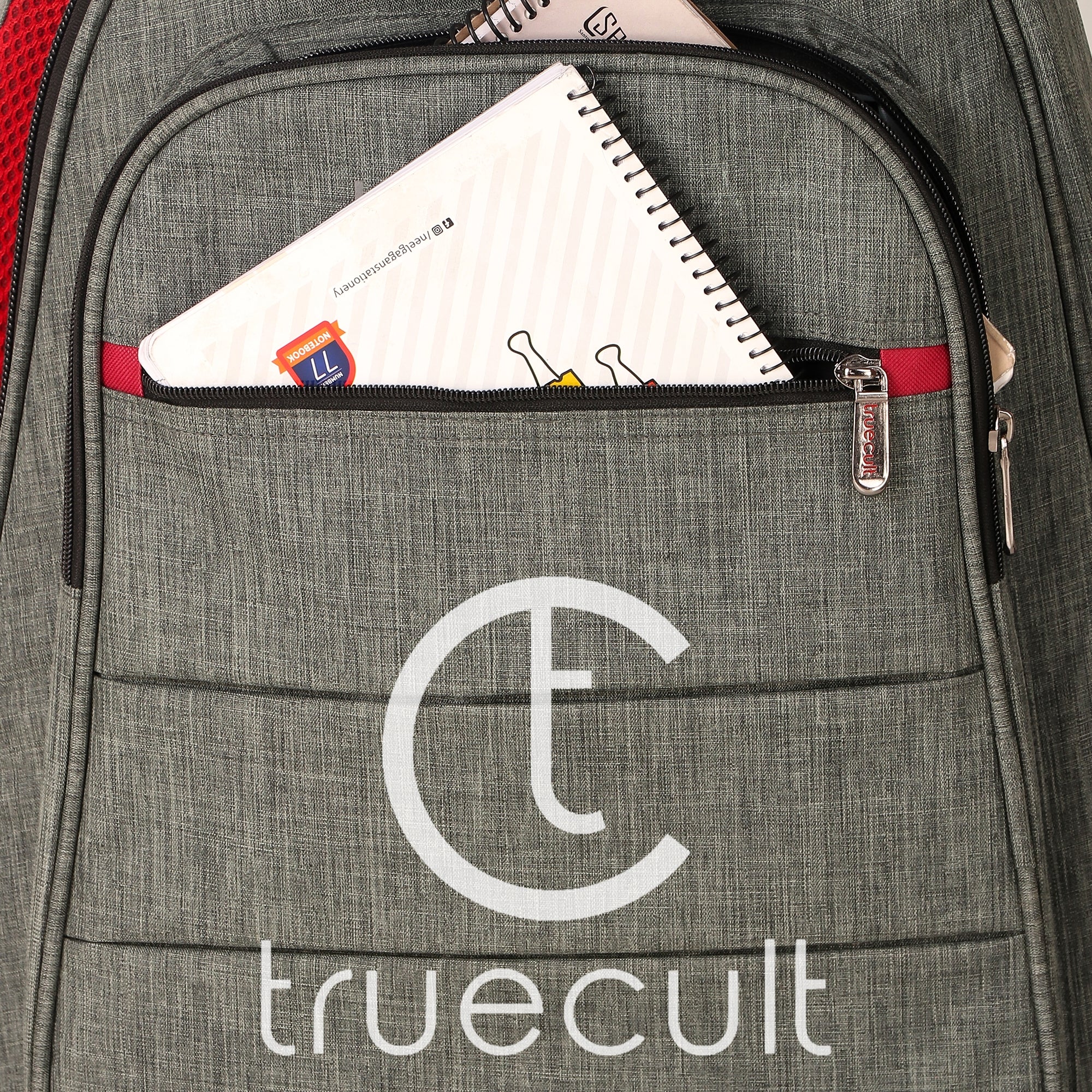Gray backpack with a visible 'truecult' logo, open front pocket showing notebooks. Water-resistant acoustic guitar gig bag for yamaha kadence fender 